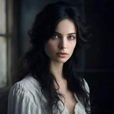 a woman with long black hair and blue eyes is posing for a photo in front of a window