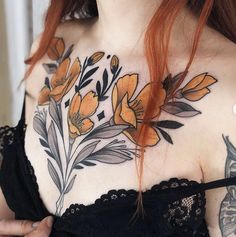 a woman with red hair and tattoos on her chest