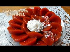 a plate topped with sliced up tomatoes on top of a doily