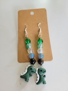 Long aromantic pride dino earrings made with glass beads and hypoallergenic hooks. Dino Earrings, Favorite Jewelry, Jewelry Earrings Dangle, Etsy Earrings, Etsy Accessories, Glass Beads, Dangle Drop Earrings, Accessory Gift, Handmade Items