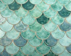 a close up view of the scales of a fish's tail pattern on a tile wall