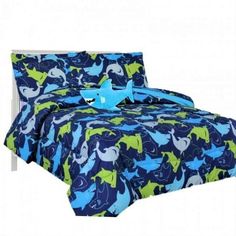 a bed with blue and green sheets on it