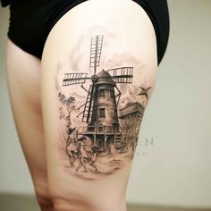 a woman's thigh with a windmill tattoo on it