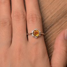 It is natural citrine ring, the main stone is about 7mm*7mm, round cut, weight about 1.25 carats. The basic metal is sterling silver and plated with rhodium. To change the metal to a solid gold (white/rose) or platinum is also available, please ask for a quotation if you want. You can also go to my shop Home for more elegant rings: https://www.etsy.com/shop/godjewelry?ref=hdr_shop_menu Natural citrine is November birthstone. More natural citrine rings: https://www.etsy.com/shop/godjewelry?ref=se Topaz Citrine Ring With Center Stone, Citrine Birthstone Ring With Accent Stones, Topaz Ring With Yellow Sapphire And Accent Stones, Round Topaz Ring With Citrine Center Stone, Round Topaz Ring With Yellow Sapphire And Accent Stones, Yellow Sapphire Topaz Ring With Accent Stones, Yellow Topaz Round Ring, Amber Topaz Promise Ring, Yellow Topaz Promise Ring, Round Cut