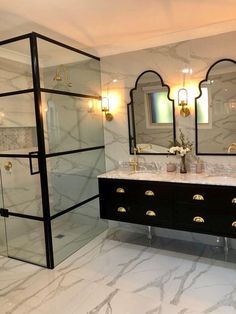 a bathroom with marble counter tops and double sinks in the center, along with mirrors on the wall