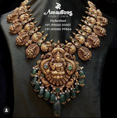 an elaborate necklace is displayed on a mannequin's neckline in gold and green