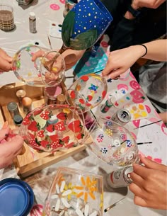 a group of people standing around a wooden box filled with candy