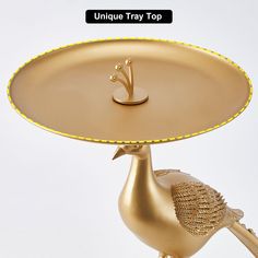 a golden tray with a bird on it and the words unique tray top above it