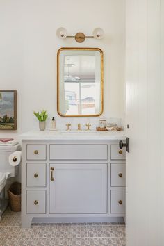 a bathroom with a sink, mirror and toilet