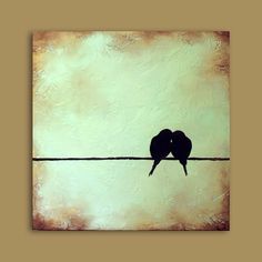 two birds are sitting on a wire and kissing