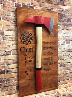 "Firemen never die they burn in our hearts forever! This is an amazing Fireman's gift.This is a well crafted piece that is perfect for giving to the firemen who run into danger to save those in need. This wooden sign is perfect as gift for the firehouse, someone becoming a new fireman or retiring from the fire department. The cherry wood stained board is approx. 20\" tall and 12\" wide and is drilled to hold the 20\" fireman's axe. These do come with the black cover for the axe which can be remo Fire And Ems Wood Flag, Bulk Fireman Gifts, Wooden Firefighter Gifts, Firemen Gifts From Kids, Retirement Firefighter Gifts, Christmas Gifts For Firemen, Fire Hose Crafts, Fire Dept Decor, Fire Department Decor