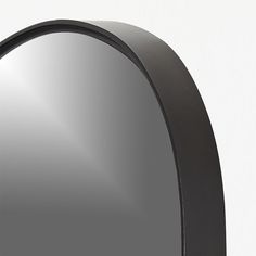 an oval shaped mirror is shown against a white wall