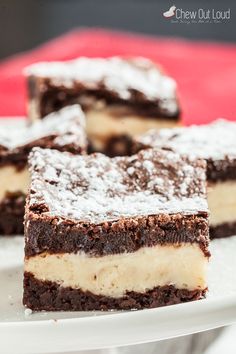 several pieces of cake on a plate with powdered sugar and chocolate in the middle