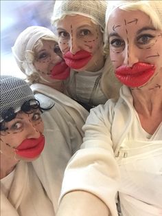 four women with their faces painted like clowns