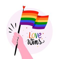 a hand holding a rainbow flag with the words love wins on it and stars in the background