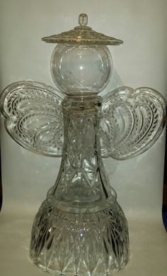 a clear glass candle holder sitting on top of a table