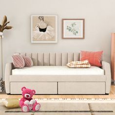 a living room filled with furniture and a pink teddy bear sitting on top of a rug