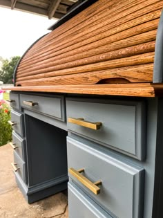 a close up of a wooden desk with drawers on the top and bottom part of it