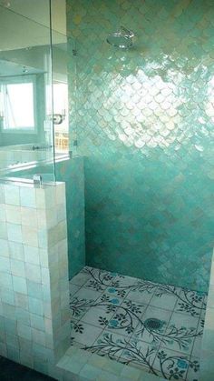 a bathroom with a tiled floor and walls in the shower area, along with a walk - in shower