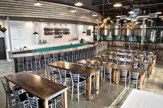 an empty restaurant with wooden tables and chairs