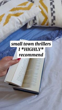 a person is holding an open book with the words small town thrillers highly recommend