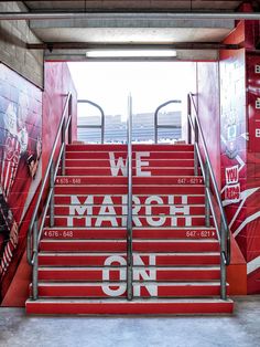 the stairs are painted red and white with we march on written on them in large letters