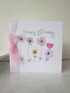 a birthday card with flowers and a pink bow