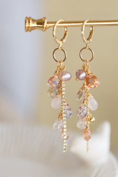 "This beautiful earrings are made from handful of gemstone like Quartz, Amethyst, Amtrine, Rose Quartz, and Pearl in 14K gold filled wires. They are carefully hung on a ring that dangling under a small gold ear hoop. The pictures do not do this earrings justice Let this unique accessory be your everyday adventures or a great gift for the loved one! Because each item is handmade there may be differences from the picture viewed. Each stone/ piece is unique and no two pieces will be exactly alike. Small Gemstone Jewelry, Handmade Stone Earrings, Earring Cluster, Rose Quartz And Pearl, Diy Earrings Dangle, Hoop Earrings Diy, Handmade Dangle Earrings, Gem Earrings, Everyday Adventures