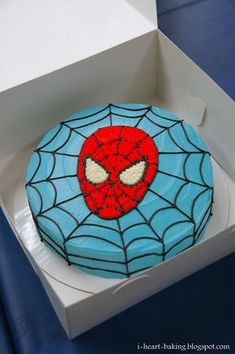 a spiderman cake in a white box