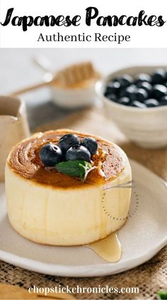 japanese pancakes with blueberries and sauce on a plate