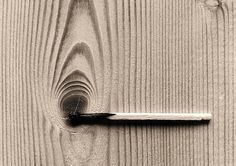 a door handle on a wooden door with wood grained boards in black and white