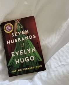 the seven husbands of evelyn hugo by taylor jenkins red on a bed