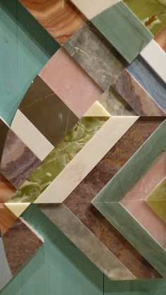 an abstract design made up of many different colors and shapes on the wall with marble