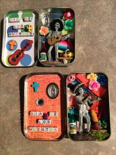 three tins filled with assorted items on top of a table next to each other