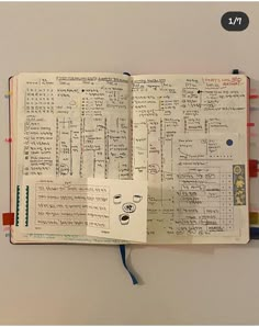 an open notebook with lots of writing on it