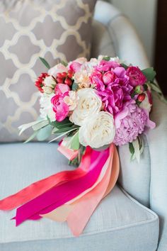 a bouquet of flowers sitting on top of a couch