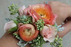 a close up of a person's wrist with flowers on it