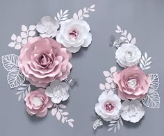 paper flowers are arranged on a gray background