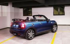 a small blue car parked in a garage