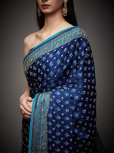 Editor's Note Embrace royal elegance with our royal/turquoise ari with tikki-h embroidered parampara ari 60 kasab sari, complete with an unstitched blouse. This ensemble is the epitome of traditional opulence, perfect for special occasions and events where you want to make a regal and sophisticated statement. The intricate embroidery and rich color combination ensure you stand out and leave a lasting impression. With the convenience of an unstitched blouse, you can customize your look to your li Luxury Royal Blue Banarasi Silk Dupatta, Blue Dola Silk Pre-draped Saree With Zari Weaving, Blue Dola Silk Pre-draped Saree With Pallu, Blue Bollywood Banarasi Silk Pre-draped Saree, Blue Raw Silk Pre-draped Saree For Festivals, Festive Blue Art Silk Pre-draped Saree, Blue Katan Silk Pre-draped Saree, Blue Katan Silk Pre-draped Saree With Zari Work, Festive Blue Tussar Silk Pre-draped Saree