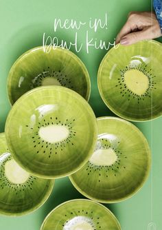 four kiwi bowls are stacked on top of each other, with the words new up beneath them