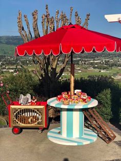 a table with an umbrella and some food on it