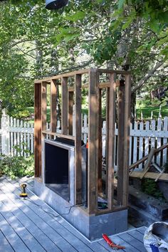 an outdoor fireplace built into the side of a wooden deck