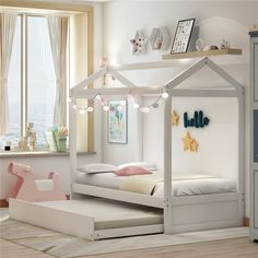 a child's bedroom with white furniture and pink accessories