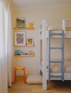 a bedroom with bunk beds and pictures on the wall