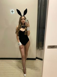 a woman in a bunny costume taking a selfie