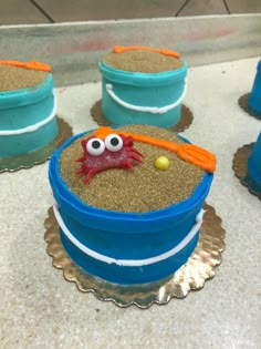 there is a cake in the shape of a bucket with sand inside and eyes on it