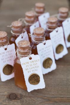 honey bottles with labels on them are sitting on a table next to some penn coins