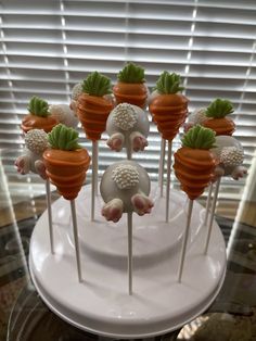 there are many cake pops with carrots in the shape of animals on them,