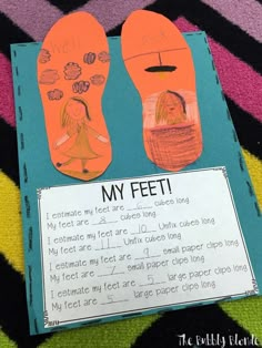 a paper cut out of two feet with the words my feet written on it and an orange shoe